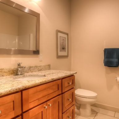 Main bathroom including updated vanity and granite countertops.