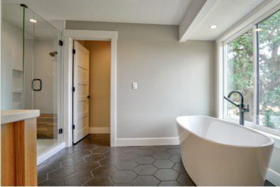 bathroom with honeycomb time and soaking tub