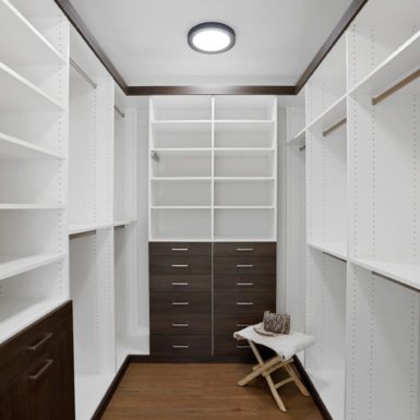 Primary Bedroom Walk In Closet With Built In Custom Cabinets