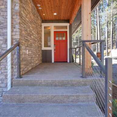 Exterior Front Entrance Red Door And Light Culture Stone And Light Stained Ceiling And Post