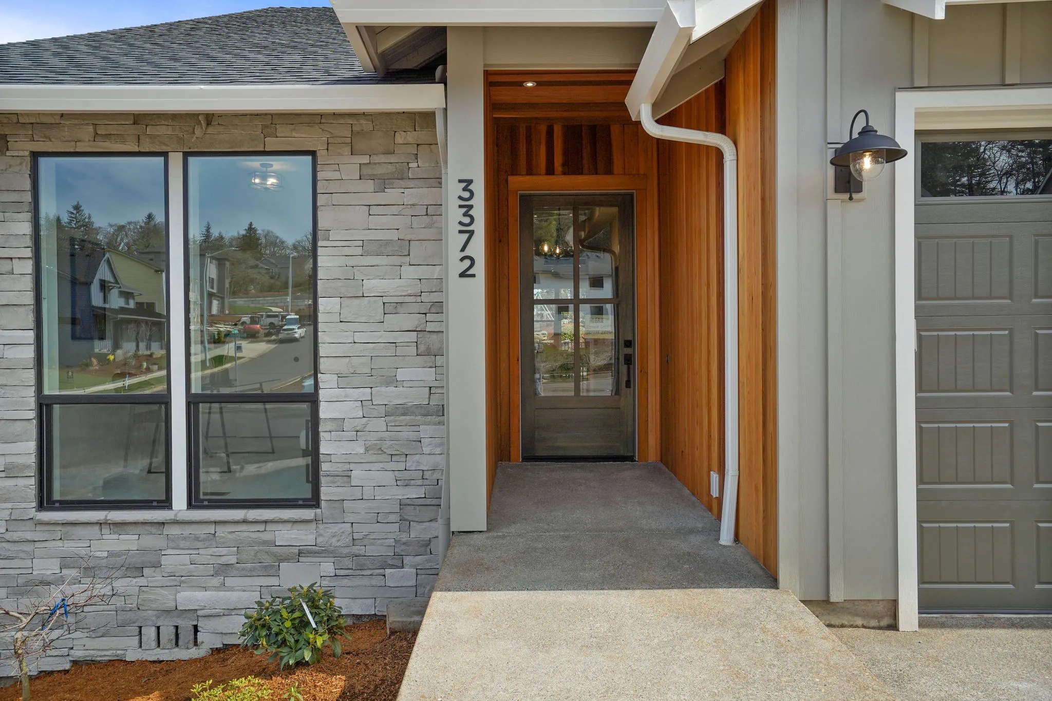 Exterior Front Entrance With Stained Wood Ans Grey Cultured Stone