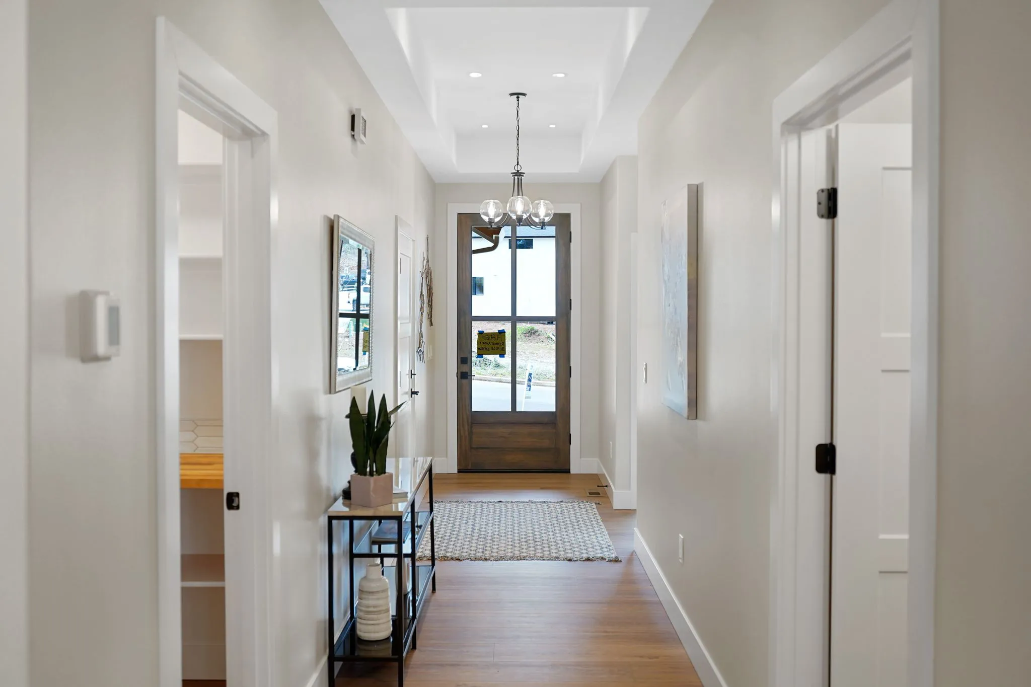Interior Entry View With Tall Stained Entry Door And White Trim