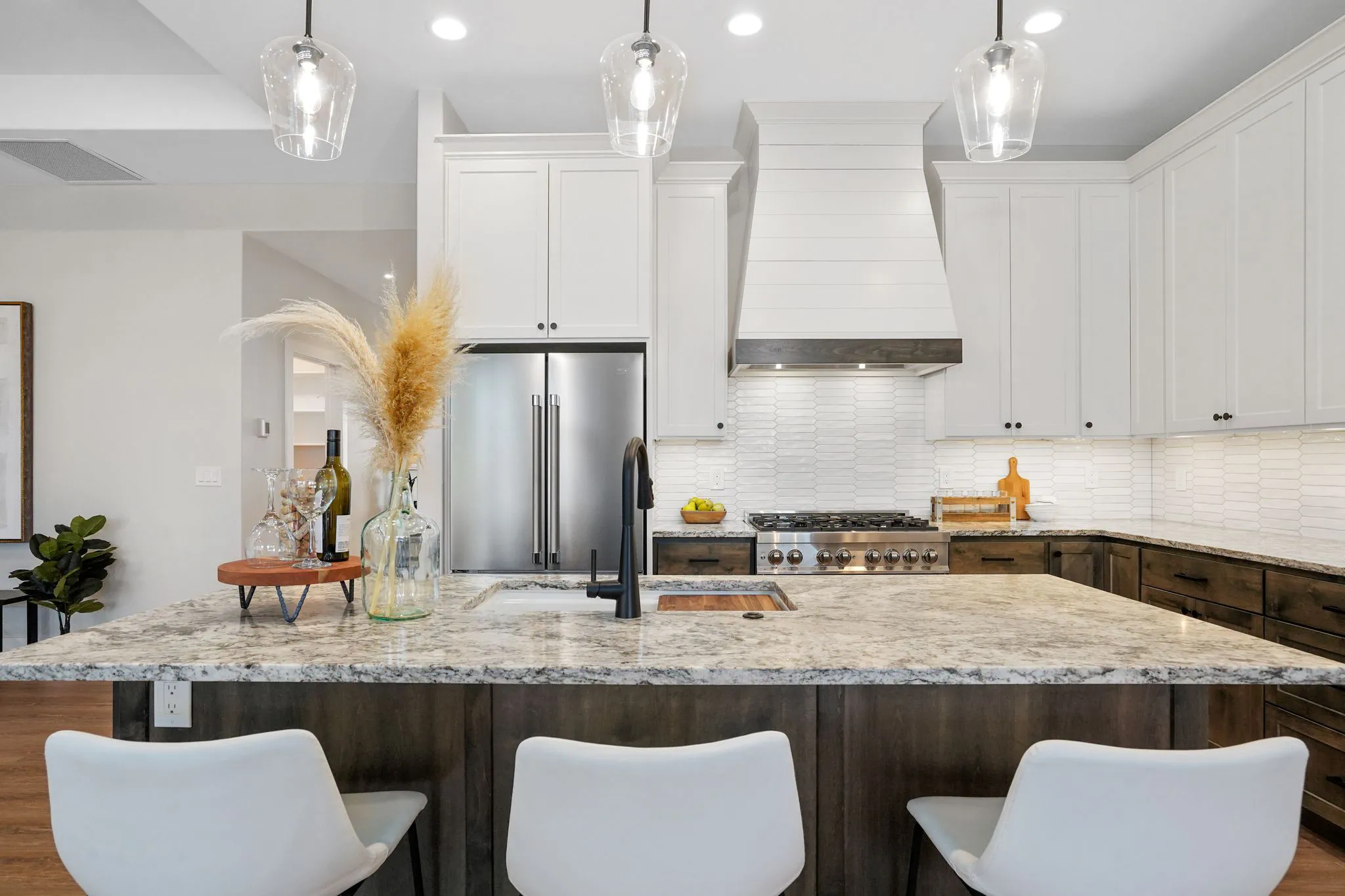 Kitchen With Large Granite Island Light Pendants And Custom Cabinets