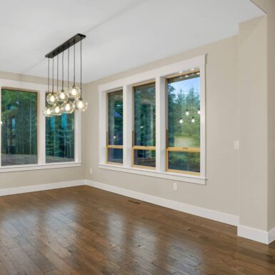 beautiful dining room area with large windows and pendant lights