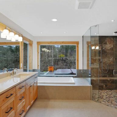 Primary bathroom custom cabinet and soaking tub and walk in shower beautifully combined