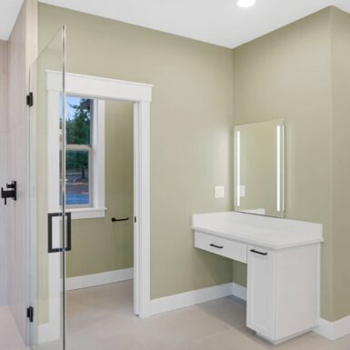primary bathroom vanity area and private toilet